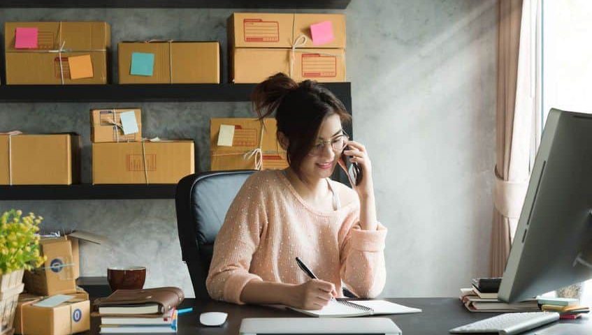 woman at desk talking on phone