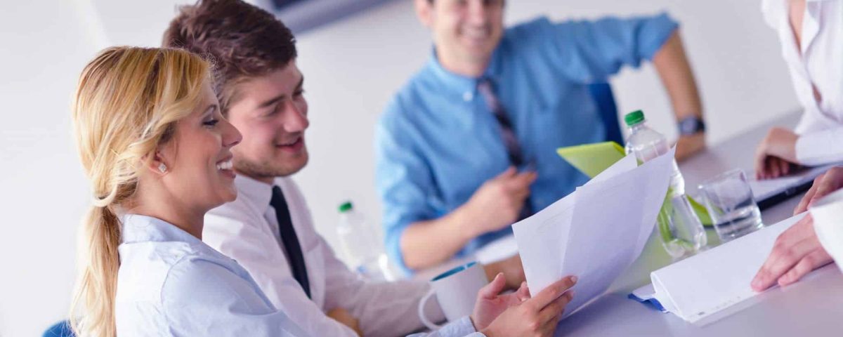 business woman showing papers to colleagues
