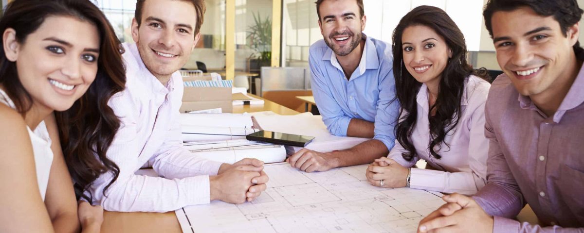 happy employees around a table at work
