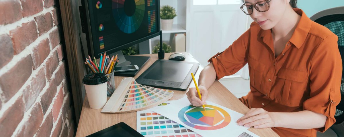 a graphic designer working on her brand’s color palette