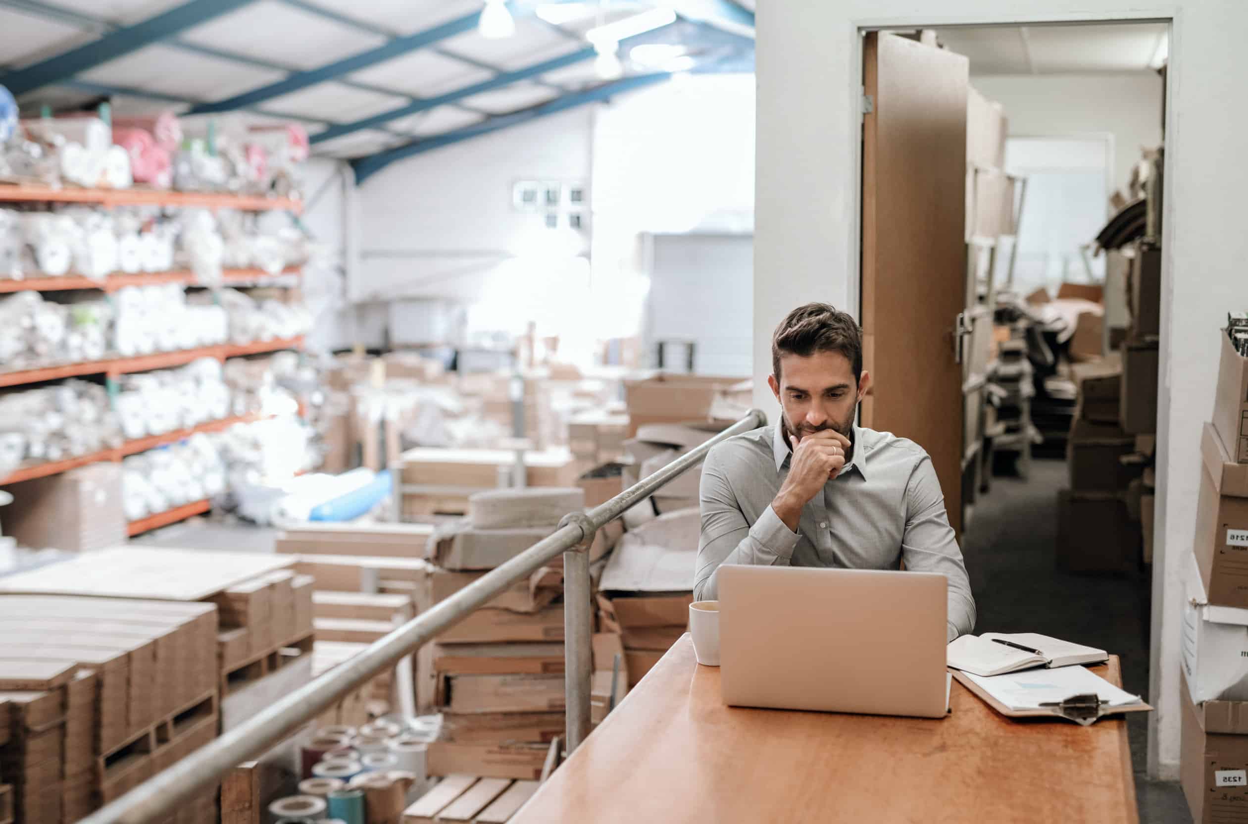 Business owner working on marketing in a warehouse.