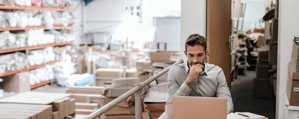 Business owner working on marketing in a warehouse.