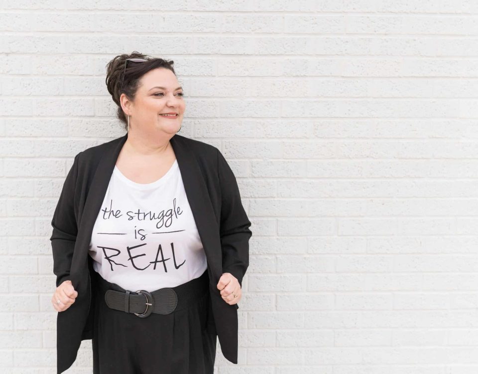 Crista Tharp leaning against a wall