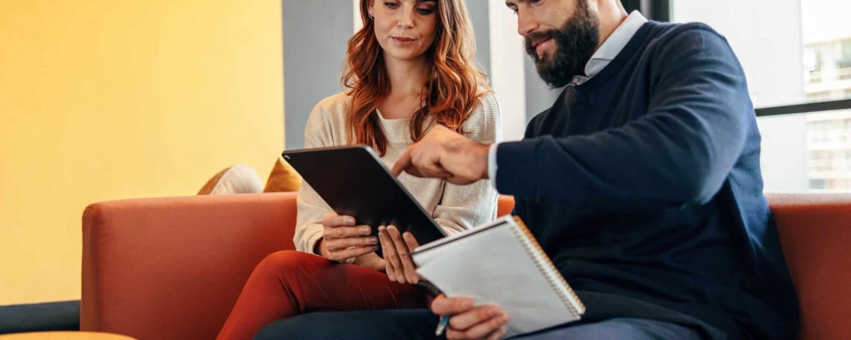 business man and woman looking at a tablet reviewing a marketing sales funnel