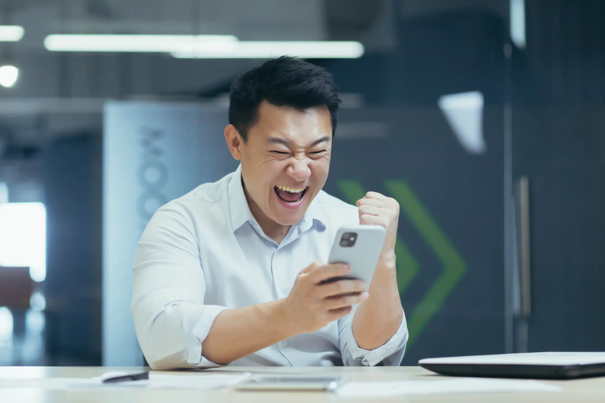 Man looking excitedly at phone