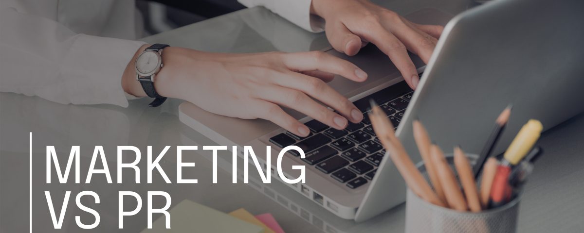 person searching marketing vs pr on laptop