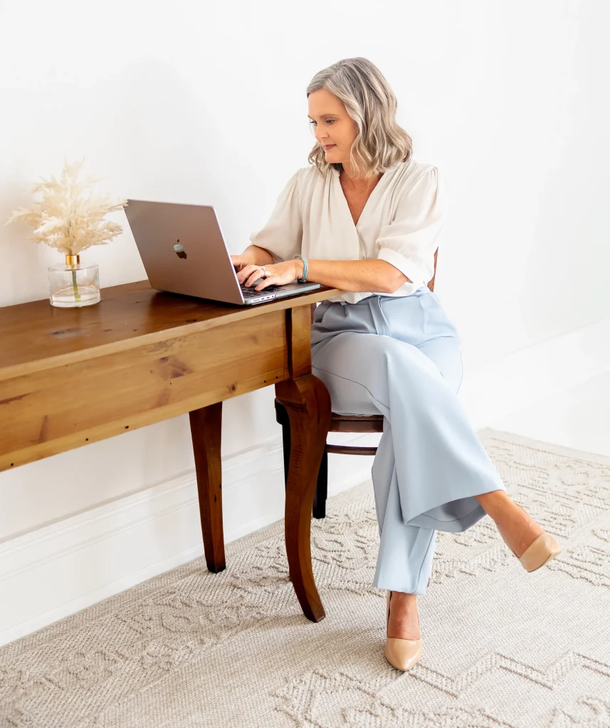 Kelly Rice, fractional CMO working on her computer